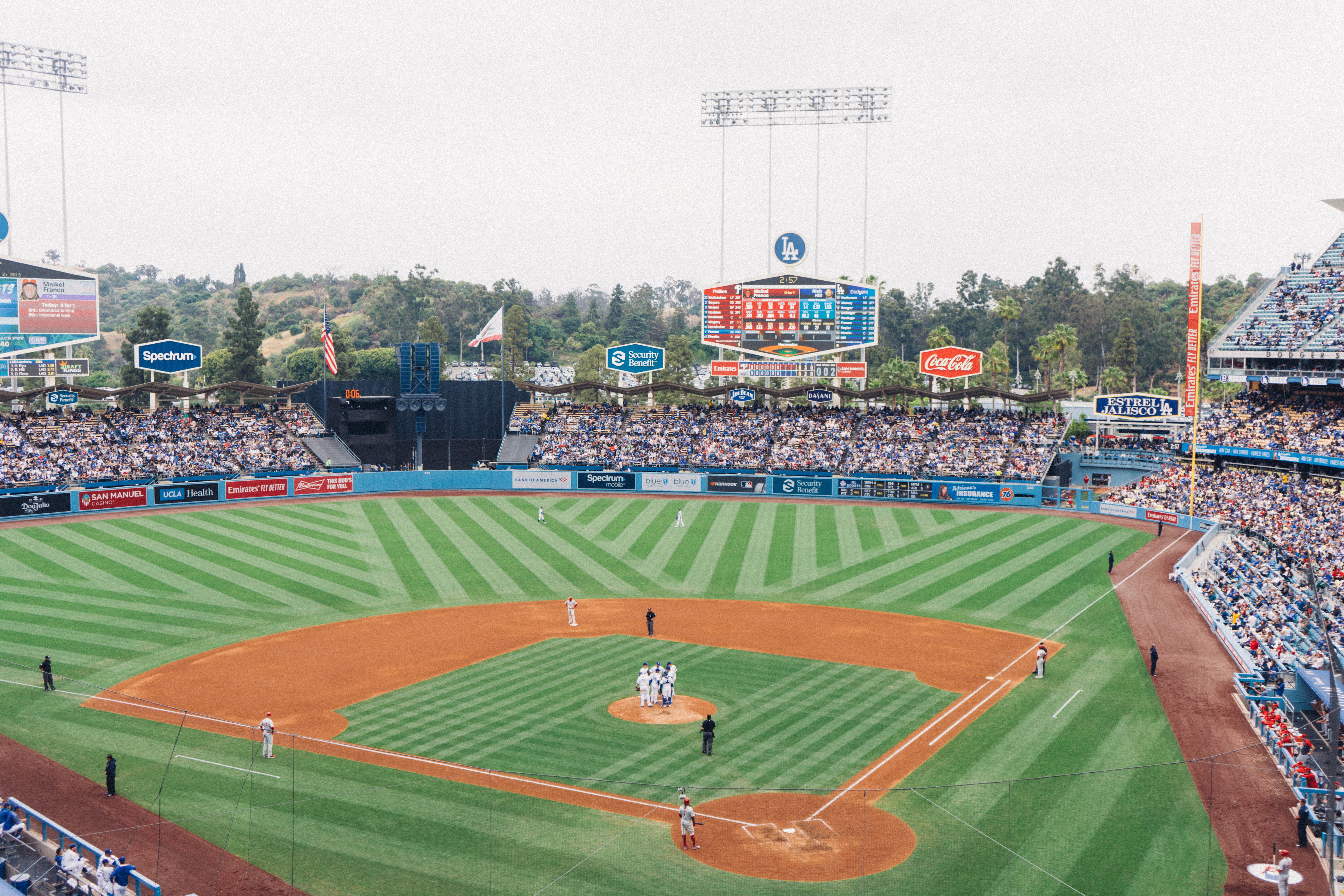 Baseball players on a field in front of a full audience