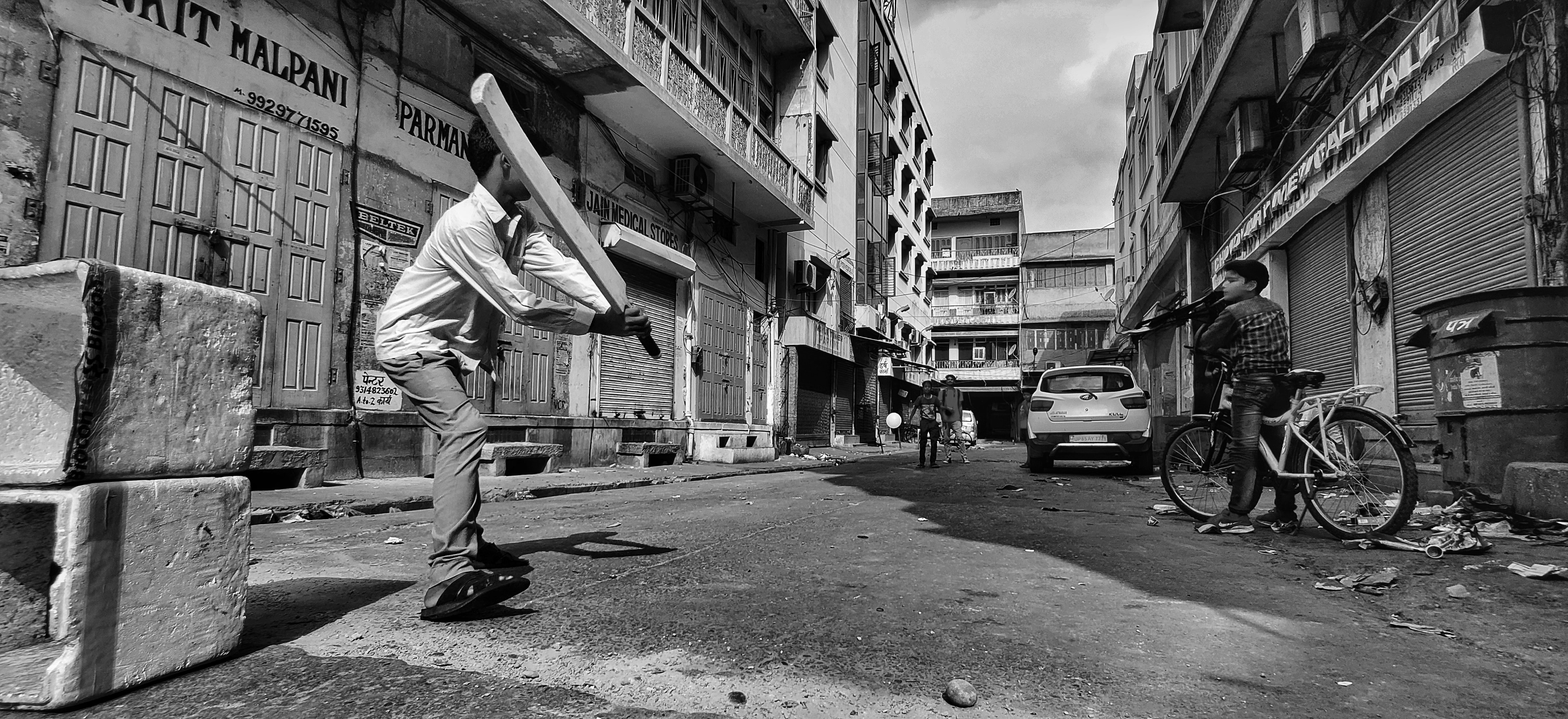 Kids playing baseball in the street